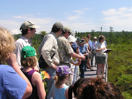 Jen Lund leads a class at the Orono Bog Boardwalk last year. The area is part of the Caribou Bog Corridor Project, an 18,000-acre focus area extending from Essex Street in Bangor along the eastern shore of Pushaw Lake to the inlet of Pushaw Lake in Hudson. CREDIT: Photo by Jerry Longcore.